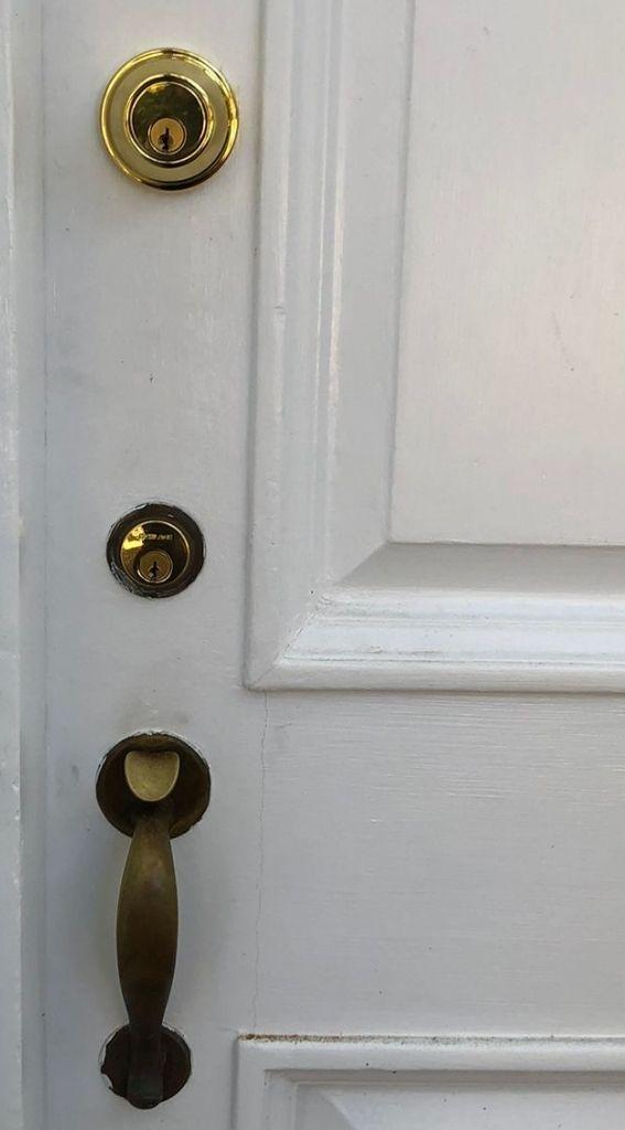 locksmith services residential locksmith door lock door lock installation emergency locksmith lock repair Close-up of a residential door featuring a gold deadbolt lock and a brass door handle, highlighting security features for homeowners in Washington, DC.