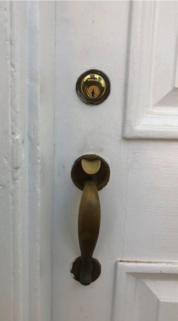 residential locksmith door lock door lock installation emergency locksmith lock repair locksmith services Close-up of a residential door lock with a brass handle and deadbolt, emphasizing security features for door repair services by MacArthur Locks & Doors in Washington, DC.