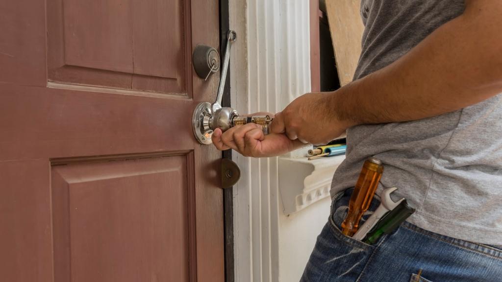 A locksmith fixing a stuck door lock latch