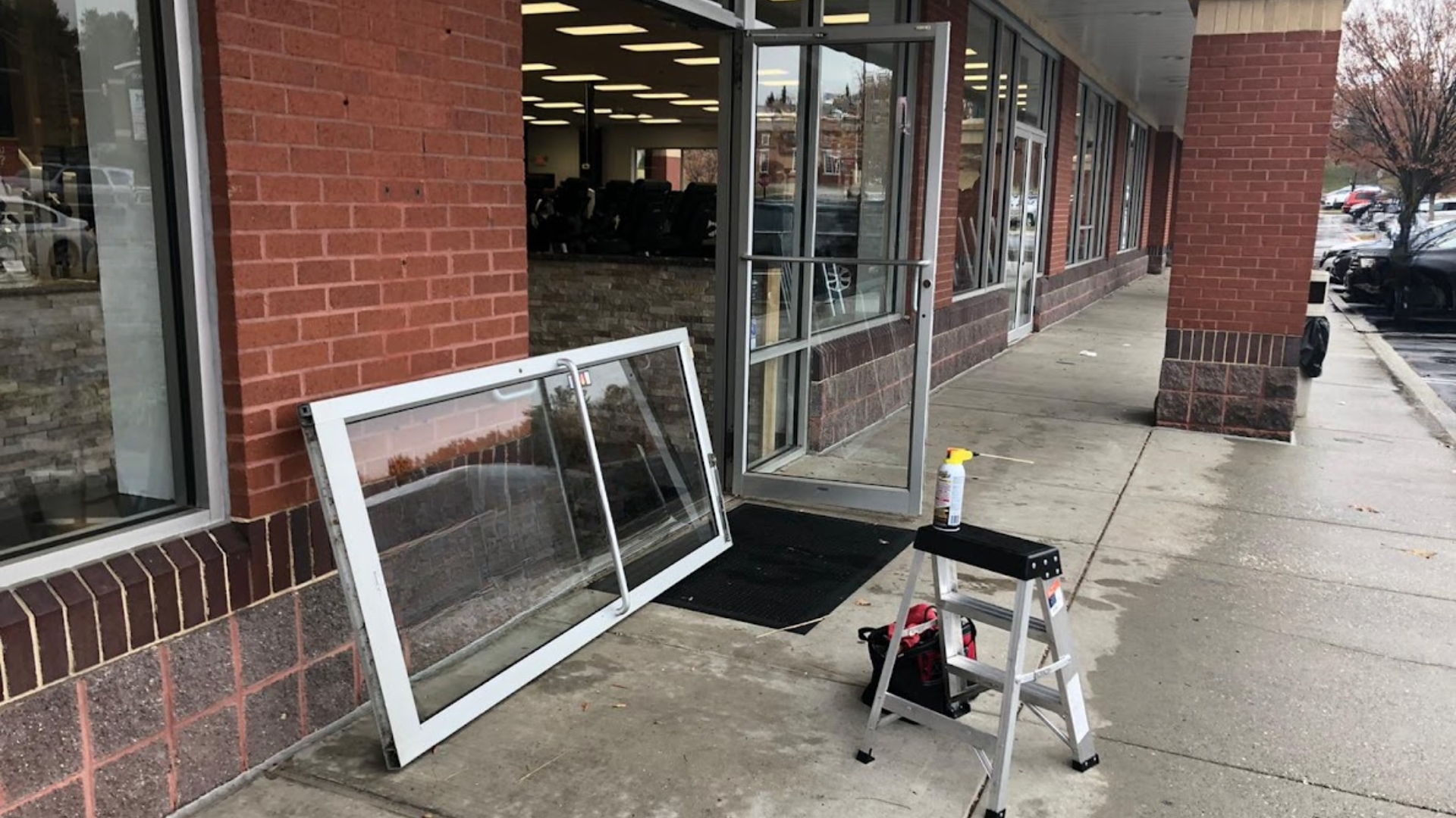 A commercial door being fixed. Binding and sagging are common commercial door problems.