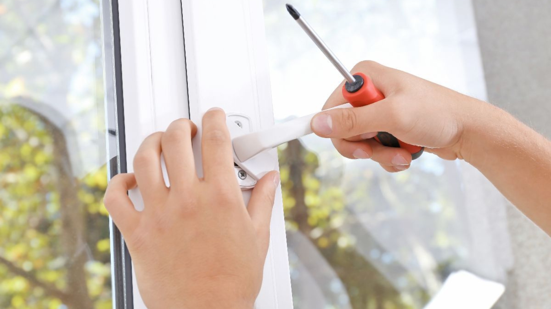 A homeowner performing window lock installation