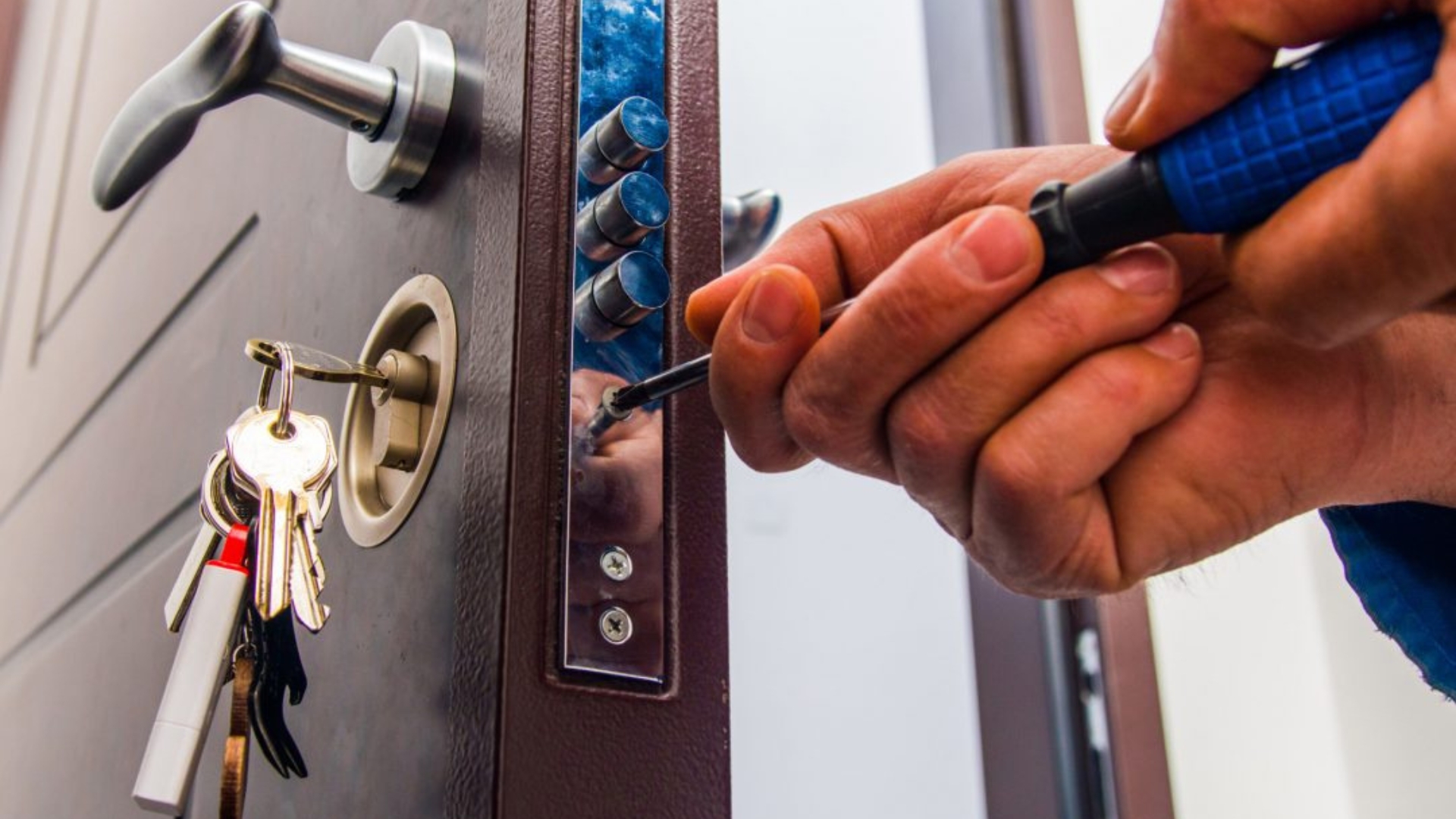 A residential locksmith installing a lock on a residential door