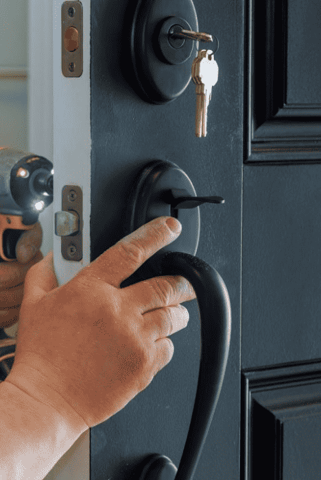 closeup-of-a-professional-locksmith-installing-a-new-lock-on-a-house-exterior-door-with-the-inside-1