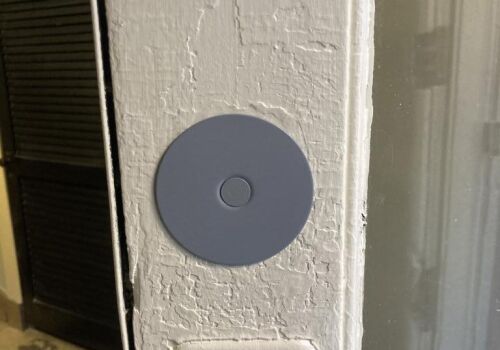 Close-up of a round gray door lock installation on a white door frame, highlighting residential security upgrades by MacArthur Locks & Doors.