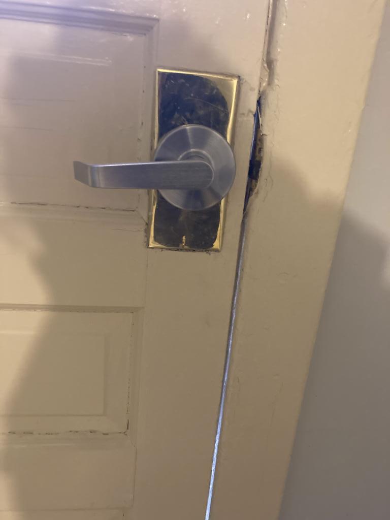Modern lever handle door lock installation on a residential door, showcasing a sleek design and secure fit, relevant to MacArthur Locks & Doors' locksmith services in Arlington, VA.