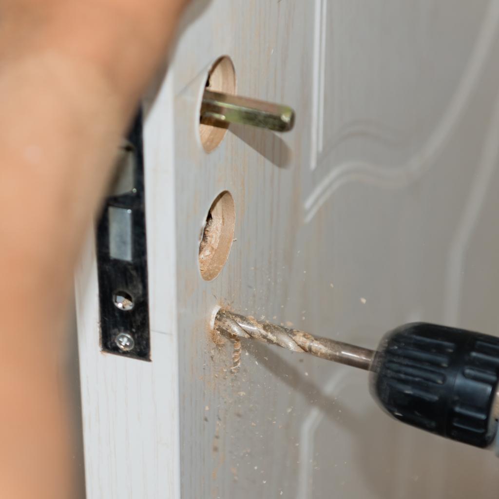Technician installing a front door lock in a Northern Virginia townhouse