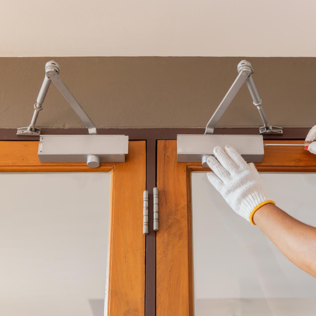 Technician adjusting hydraulic door closer in Washington DC
